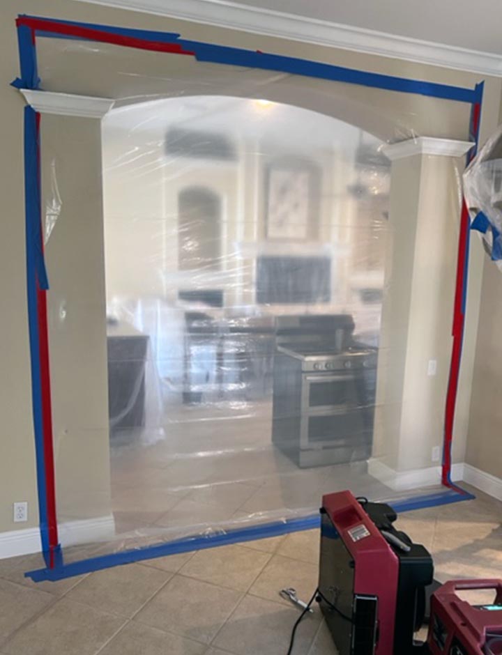 mold containment barrier and remediation taking place inside of home